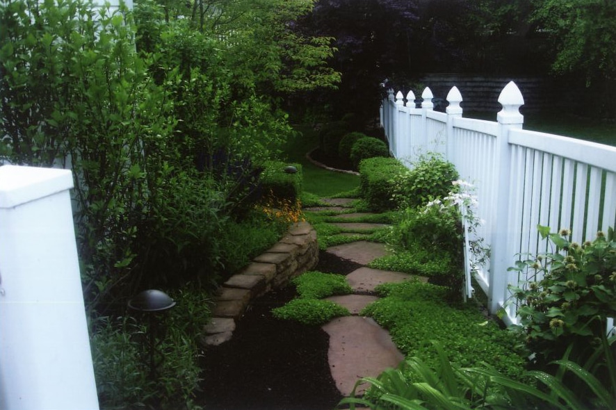Decorative Walkway with a White Fence
