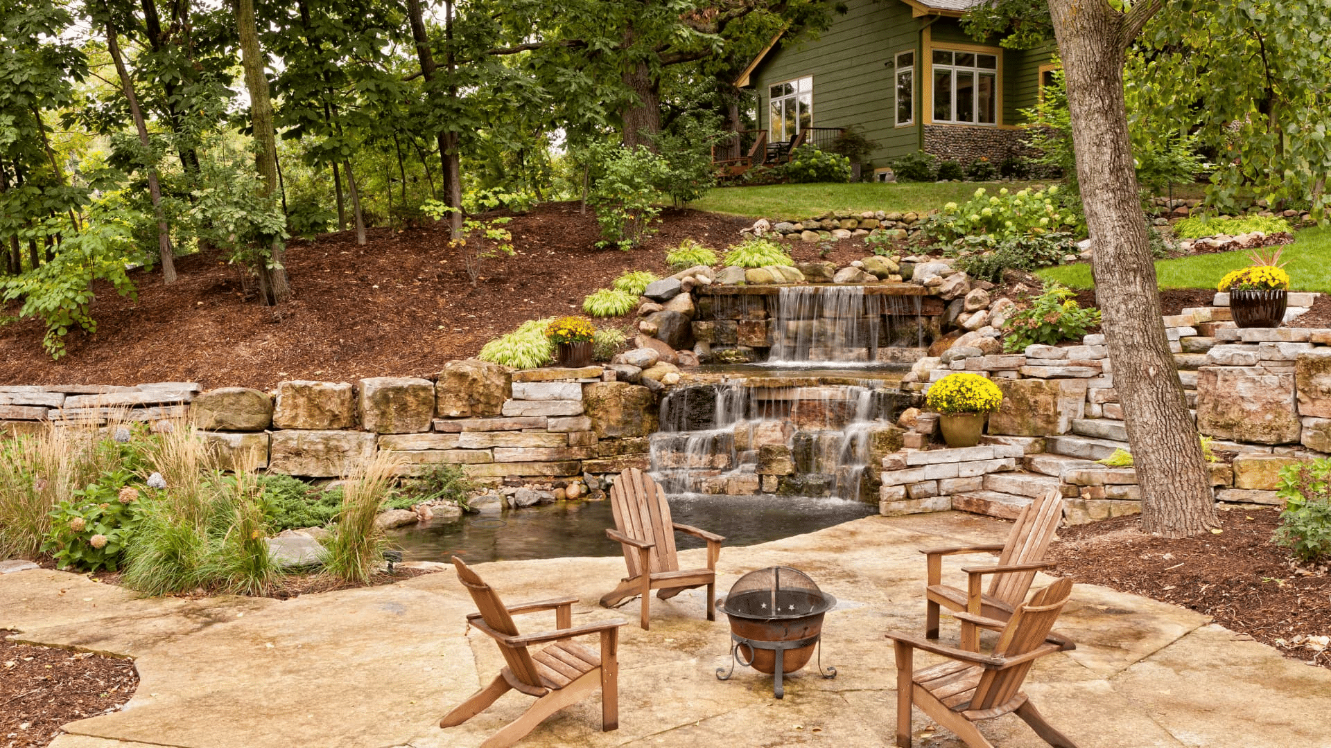 Home with backyard landscaping and water feature