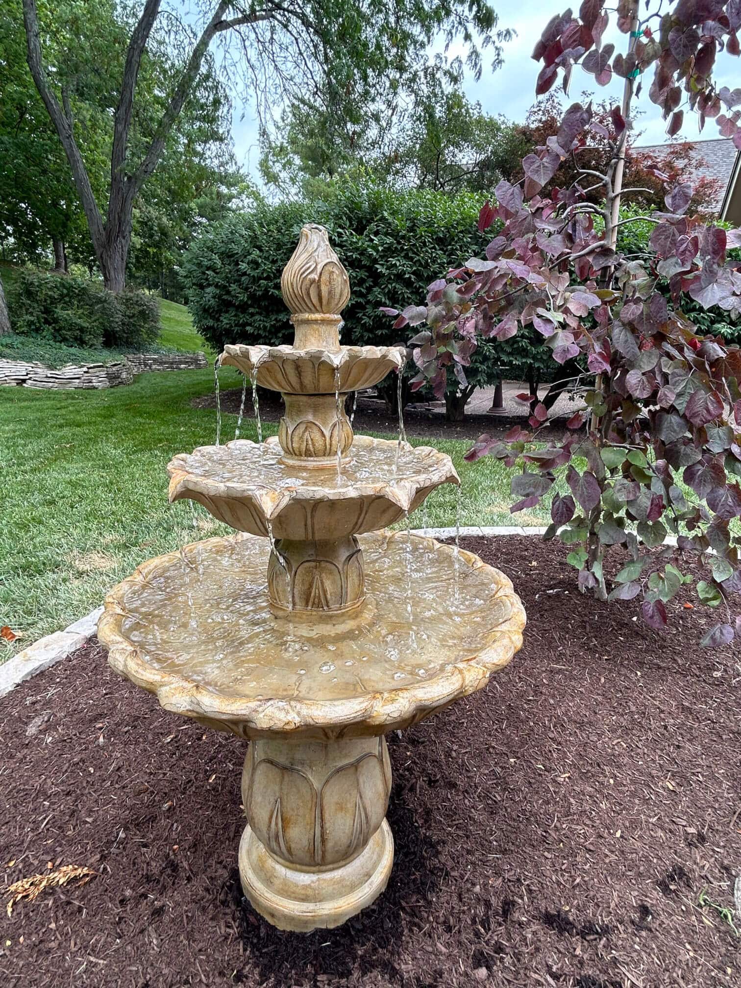 Modern landscaping with stone three-tiered waterfall feature