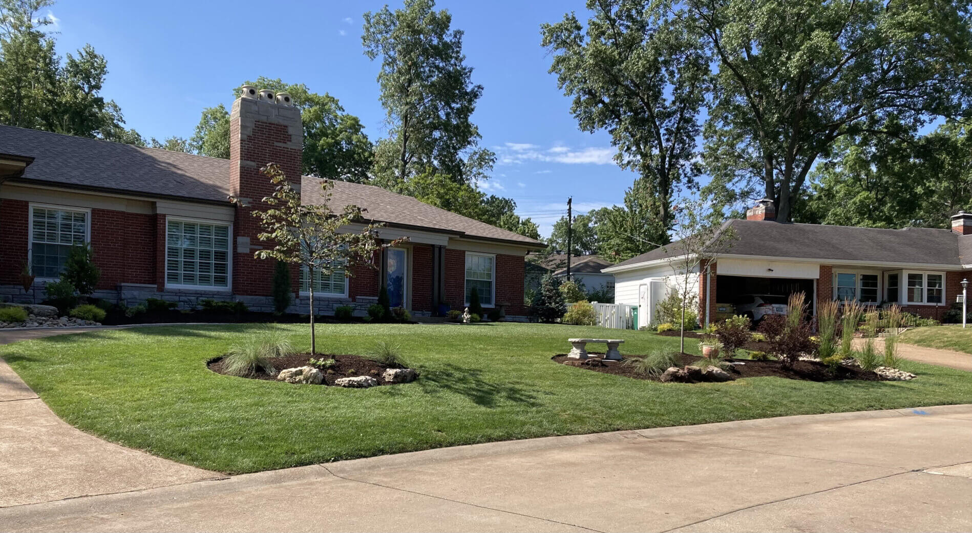 Brick home with modern landscaping in front yard