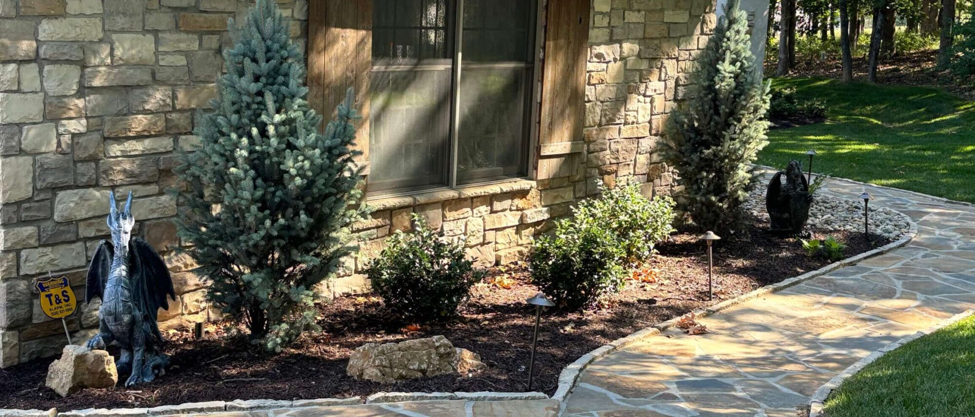 Natural stone pathway alongside natural stone house