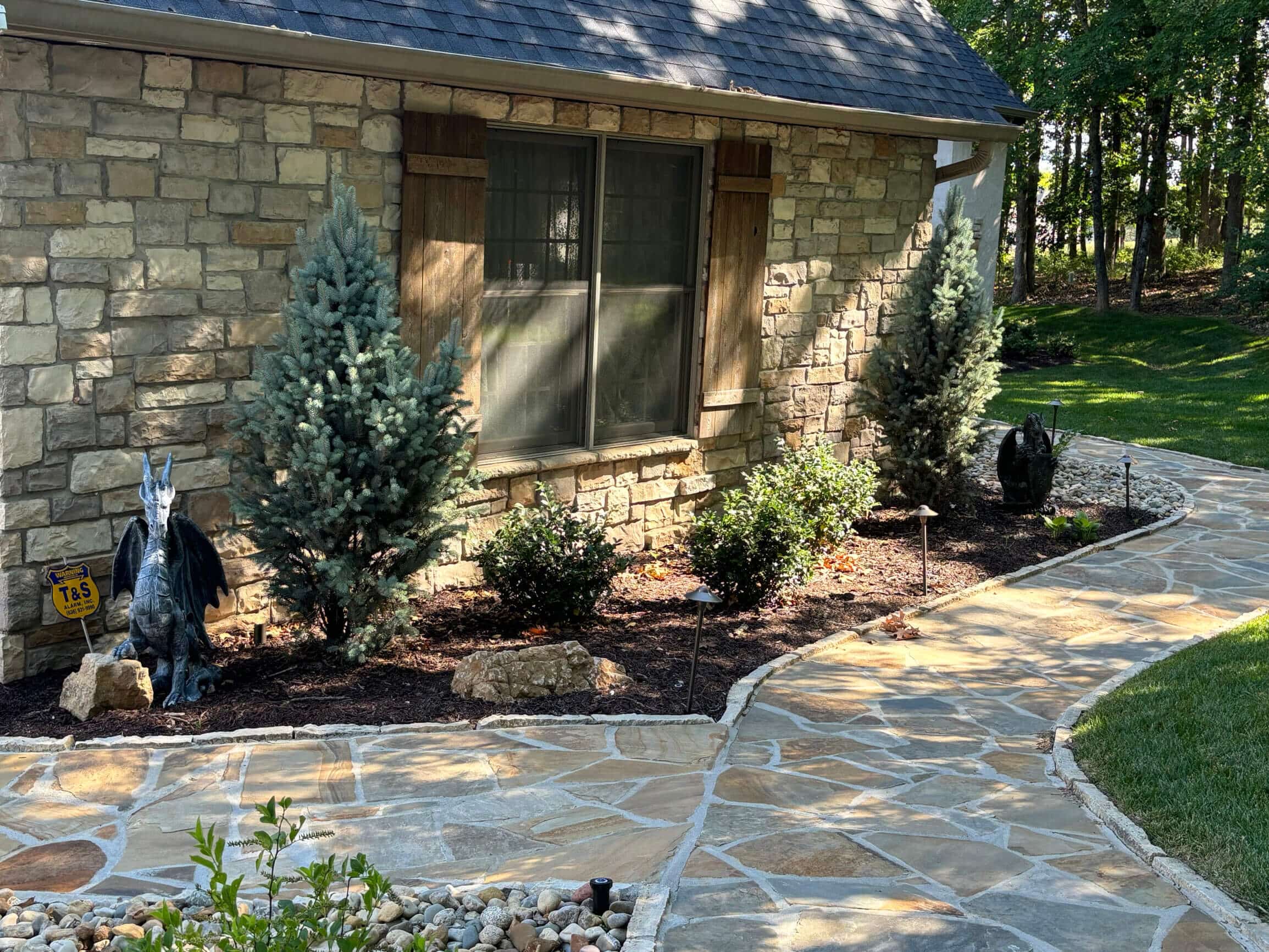 Natural stone pathway alongside natural stone house